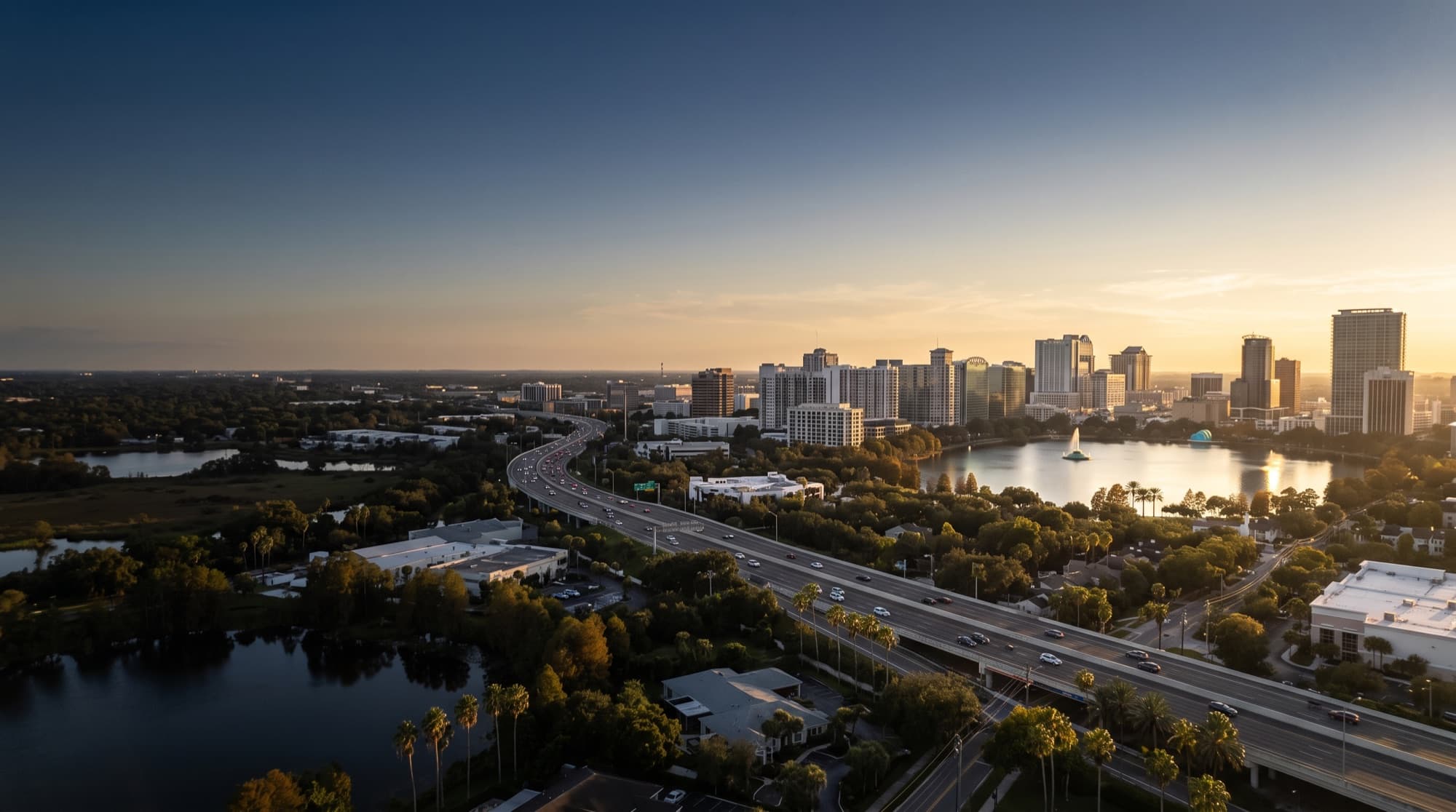 Downtown Orlando skyline and Lake Eola at golden hour above the I-4 corridor
